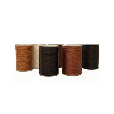 Image of multiple reels of Hairy Pony Flat Waxed Plaiting Thread in various colours, including brown, chestnut, white and black.